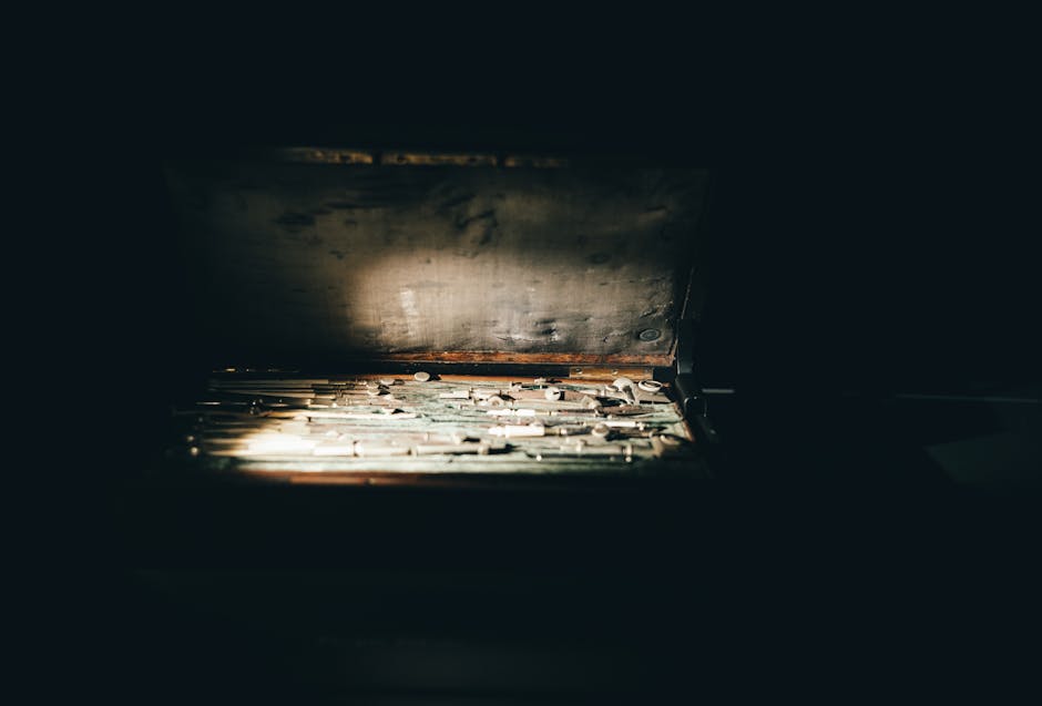 A vintage toolbox with various tools illuminated by sunlight. Captured indoors in Türkiye.