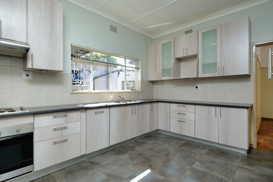Sleek modern kitchen with neutral tones and abundant natural light.
